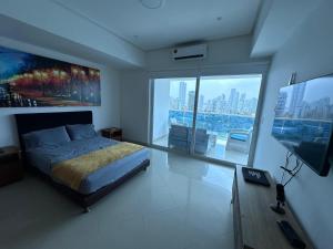 a bedroom with a bed and a flat screen tv at Cartagena De Indias in Cartagena de Indias