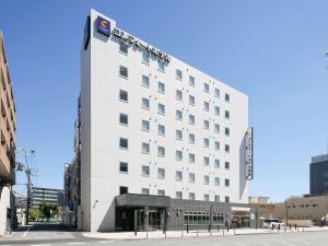 a white building with a sign on the side of it at Comfort Hotel Nara in Nara