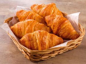 a basket filled with croissants on top of a table at Comfort Hotel Nara in Nara +19 photos