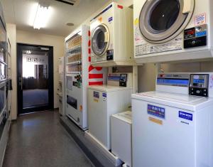 a hospital room with machines and a washer and dryer at Comfort Hotel Nara in Nara