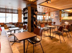 a restaurant with tables and chairs in a room at Comfort Hotel Nara in Nara