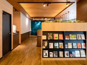 a hallway with a book shelf with books at Comfort Hotel Nara in Nara