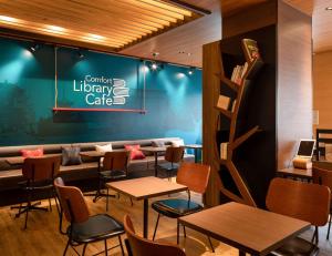 a restaurant with tables and chairs and a couch at Comfort Hotel Nara in Nara