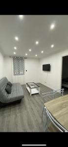 a living room with a couch and a coffee table at Chouette t2 Aiguebelle in Randens