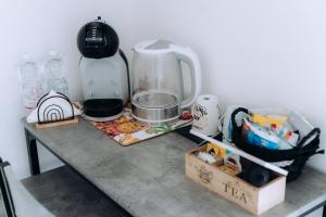 a table with a coffee maker on top of it at Sleep & Fly Villa Luisa in Case Nuove