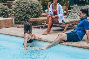 a man and a little girl playing in a swimming pool at Maison des Ambassadeurs in La Rochelle