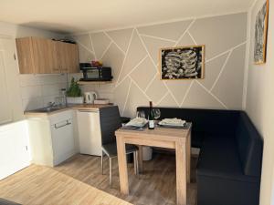 a small kitchen with a table in a small room at Ferienwohnungen AugenBlick Naumburg in Eulau