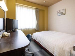 Postel nebo postele na pokoji v ubytování Comfort Hotel Kariya