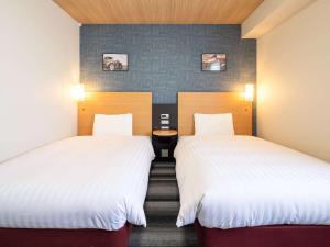 Postel nebo postele na pokoji v ubytování Comfort Hotel Kariya