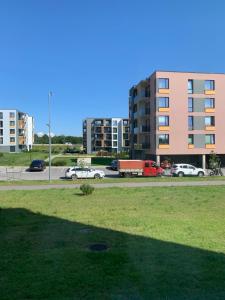 a parking lot with cars parked in a city at 1-bedroom 2 big beds MV64 in Tartu