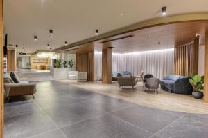 a lobby with couches and a table and chairs at Solana Hotel & Spa in Mellieħa