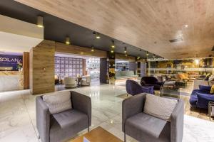 a lobby with couches and chairs in a building at Solana Hotel & Spa in Mellieħa