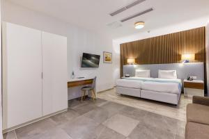 a hotel room with a bed and a desk at Solana Hotel & Spa in Mellieħa