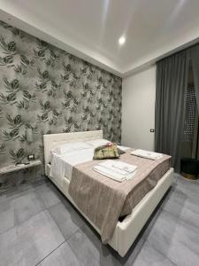 a bedroom with a large bed with a wall mural at Brighter's Room in Naples