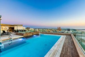 a swimming pool on the roof of a building at Solana Hotel & Spa in Mellieħa