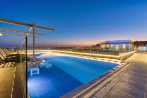 a swimming pool on the roof of a building at Solana Hotel & Spa in Mellieħa