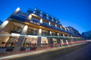 a building with a sign on the side of it at Solana Hotel & Spa in Mellieħa
