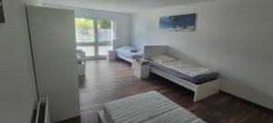 a room with two beds and a window at Workers Apartments Satzvey in Satzvey