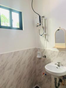 a bathroom with a sink and a mirror at Francis Dale Lodge L8 in El Nido
