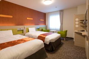 Postel nebo postele na pokoji v ubytování Comfort Hotel Miyazaki