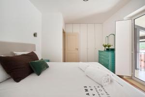 a bedroom with a white bed and a green dresser at Casa do Moleiro in Mortágua +88 photos