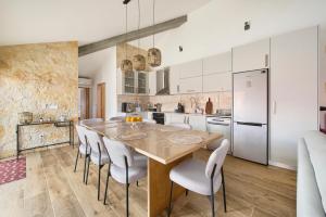 a kitchen with a large wooden table and chairs at Casa do Moleiro in Mortágua