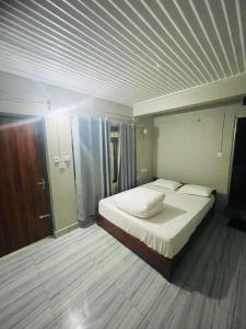 a bedroom with a large bed in a room at Deurali Guest House in Pokhara
