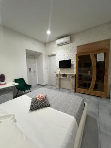 a bedroom with a large bed and a television at Brighter's Room in Naples +17 photos