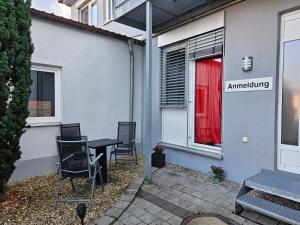 a table and chairs sitting outside of a building at Old Factory Living in Adelsdorf