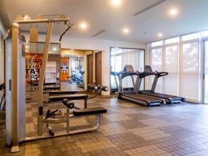 a gym with several tread machines in a room at Jhezzstuffs staycation in Iloilo City
