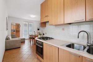 a kitchen with a sink and a stove top oven at Casa Enea Exclusive Relax Stay in Colico +20 photos