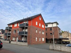 a red brick building on the side of a street at AM Apartment in Gronau