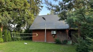 a house with a volleyball net in front of it at Domek Letniskowy na Wyłączność - Łaszka in Łaszka