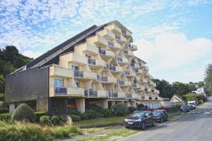 a building with balconies on the side of a street at La Brise de Donville - A 300m de la plage in Donville-les-Bains