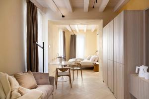 a living room with a couch and a table at PALAZZO CIOPETA - Italian Excellence in Verona