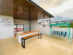 a room with a bench and a table at Lunara Villa in Batu