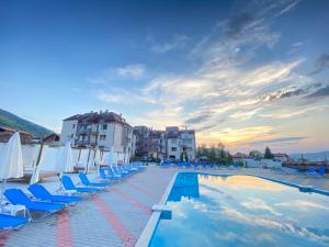 a swimming pool with lounge chairs and a hotel at Sapareva Apartments in Sapareva Banya