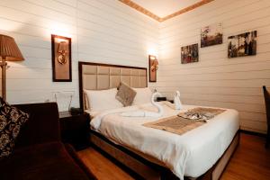 a bedroom with a bed with a swan on it at Sinon Baga Retreat in Baga