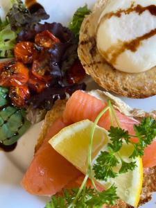 a plate of food with fish and a sandwich at The Boardwalk Inn in Summerside +16 photos