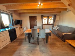 a dining room with a table and a couch at Domek u Ani in Giżycko