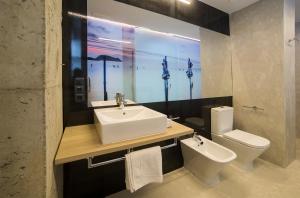 a bathroom with a sink and a toilet at Zerupe Hotel in Zarautz