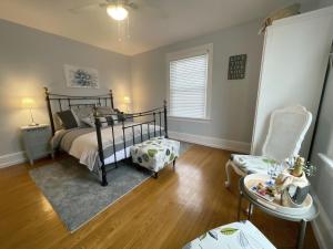 a bedroom with a bed and a chair at The Boardwalk Inn in Summerside