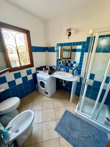 a bathroom with a toilet and a sink and a shower at Case vacanza Corallo - San Teodoro centro in San Teodoro +83 photos
