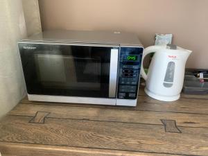 a microwave oven sitting on top of a counter at 1-bedroom 2 big beds MV64 in Tartu