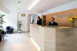 two men sitting at a counter in a restaurant at Hotel Montecarlo Santiago in Santiago