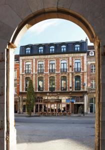 an archway in front of a large brick building at Theater Hotel Leuven Centrum in Leuven