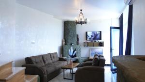 a living room with a couch and a table at Villa Harmony in Chakvi