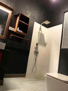 a bathroom with a shower and a toilet at Athyantha Resort in Anuradhapura