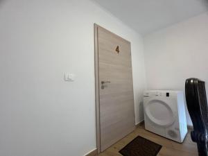 a bathroom with a toilet and a door at Villa Ivanka in Koper