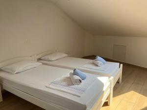 two beds in a room with towels on them at Villa Ivanka in Koper